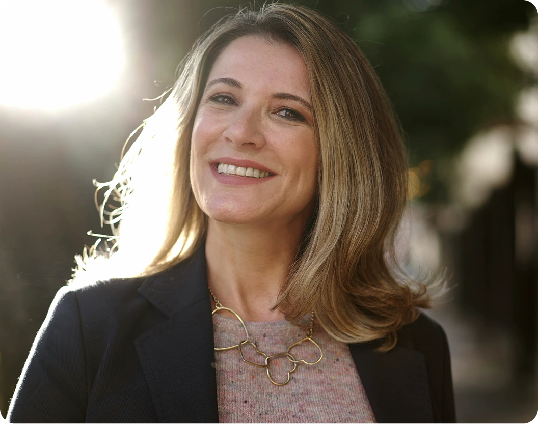 Woman smiling outdoors with natural lighting