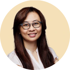 Dr. Joy Chen, dentist wearing glasses and white coat, smiling at camera