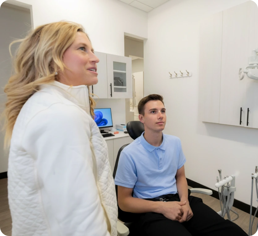 Dentist consulting with patient in treatment room at Maryland Holistic Dentistry's Dunkirk location